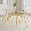 A modern minimalist style round transparent tempered glass table with gold metal legs